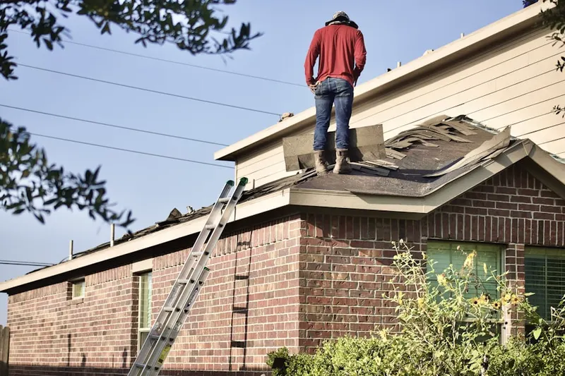 Professional roofer working on a residential roof in Westland